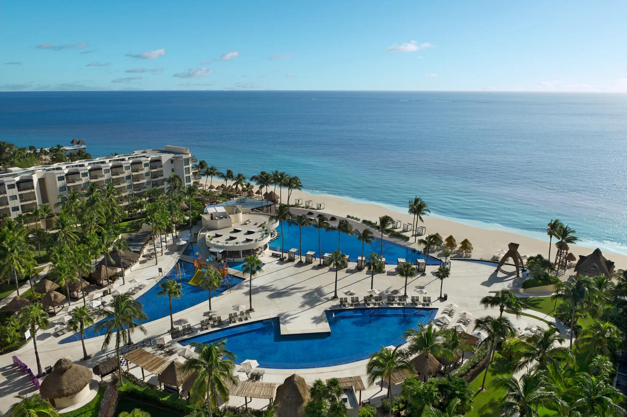 Aerial view of all-inclusive resort pools and beach — honeymoon resort packages Canada