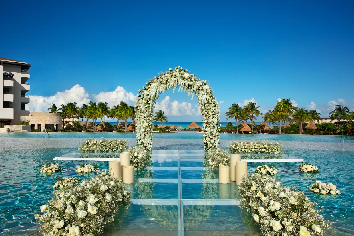 Dominican Republic wedding ceremony setup on Punta Cana beach with white chairs and tropical flowers
