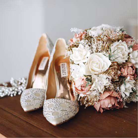 floral arrangement with wedding shoes