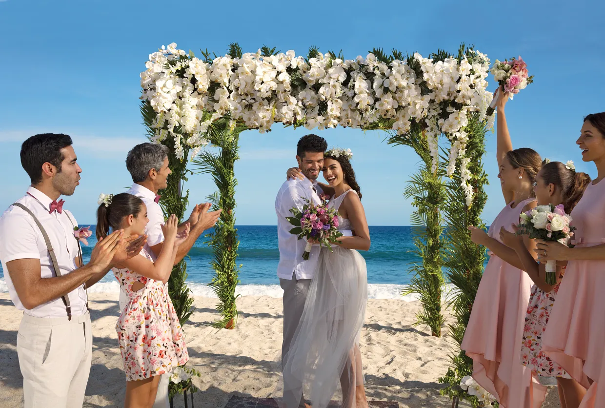 Dominican Republic wedding ceremony setup on Punta Cana beach with white chairs and tropical flowers