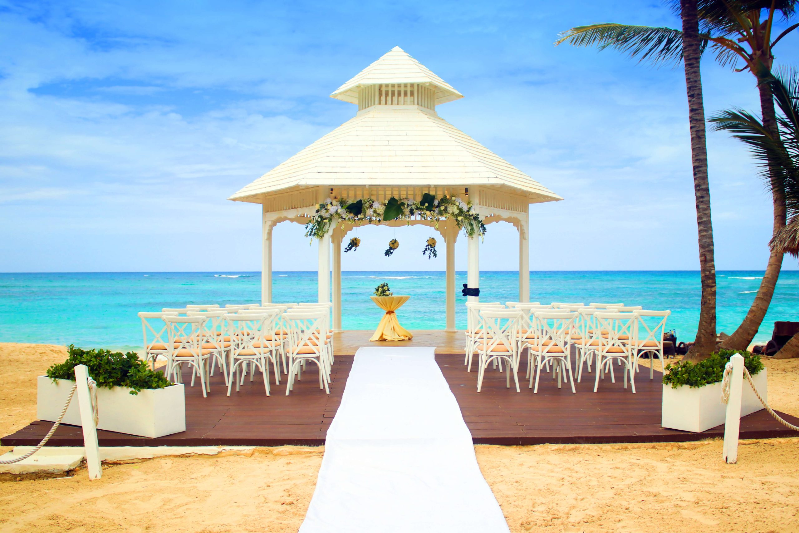 Punta Cana wedding ceremony setup on white sand beach with ocean backdrop
