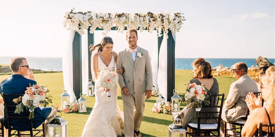 Canadian couple celebrating Jamaica destination wedding with guests overlooking the water